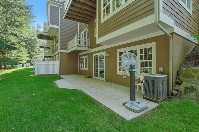 17 Deer Tree Ln, Briarcliff Manor, NY 10510 - back of property featuring central air condition unit, stucco siding, a lawn, and a patio