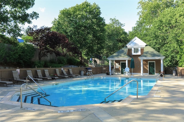 17 Deer Tree Ln, Briarcliff Manor, NY 10510 - community pool featuring a patio, grilling area, an outdoor structure, and view of wooded area