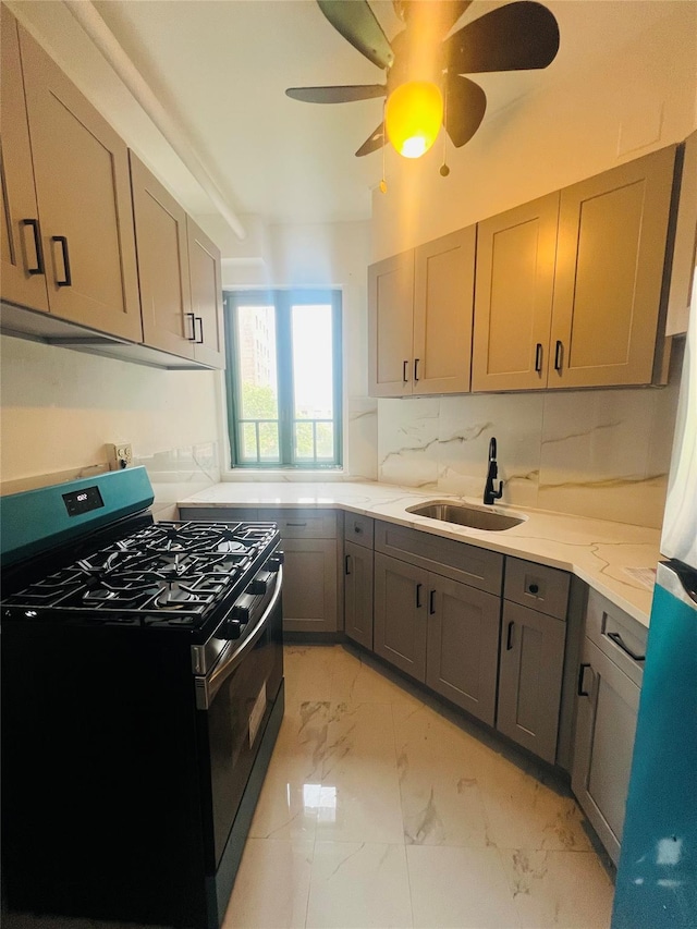 2055 Saint Raymond Ave Unit 7C, Bronx, NY 10462 - kitchen featuring stainless steel range with gas stovetop, a sink, light marble finish floors, ceiling fan, and gray cabinets
