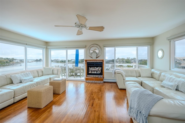 19 Cold Spring Ct, Southampton, NY 11968 - living area featuring a water view, a baseboard radiator, a ceiling fan, and wood-type flooring