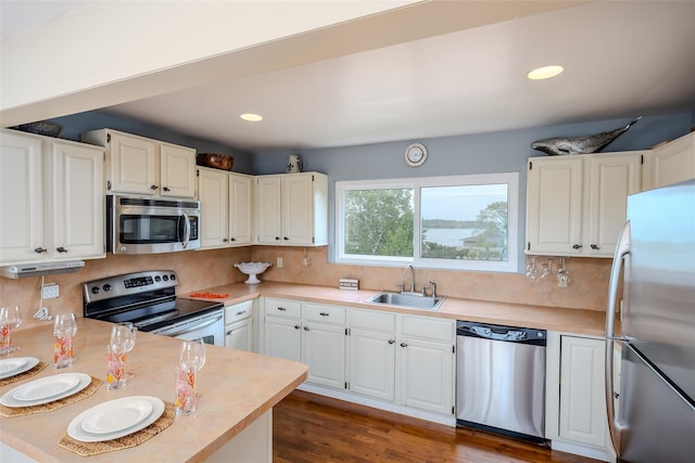 19 Cold Spring Ct, Southampton, NY 11968 - kitchen featuring stainless steel appliances, light countertops, tasteful backsplash, white cabinetry, and recessed lighting