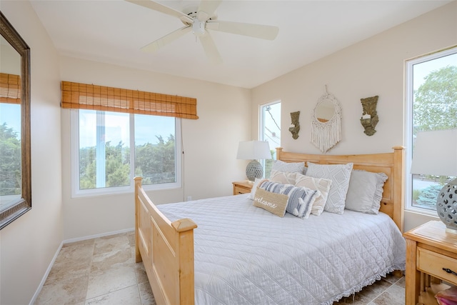 19 Cold Spring Ct, Southampton, NY 11968 - bedroom with multiple windows, ceiling fan, and light stone finish flooring