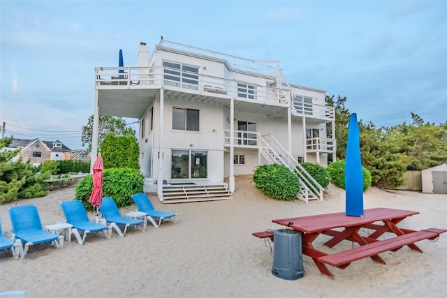 19 Cold Spring Ct, Southampton, NY 11968 - rear view of property featuring stairs, a balcony, and a storage shed