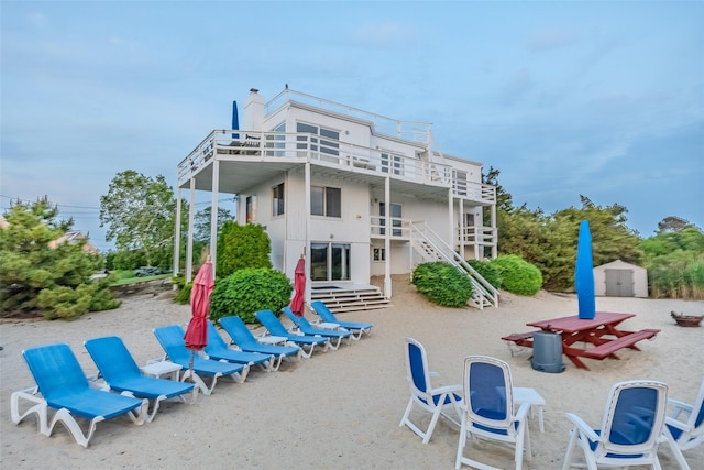 19 Cold Spring Ct, Southampton, NY 11968 - rear view of house with a shed and stairway