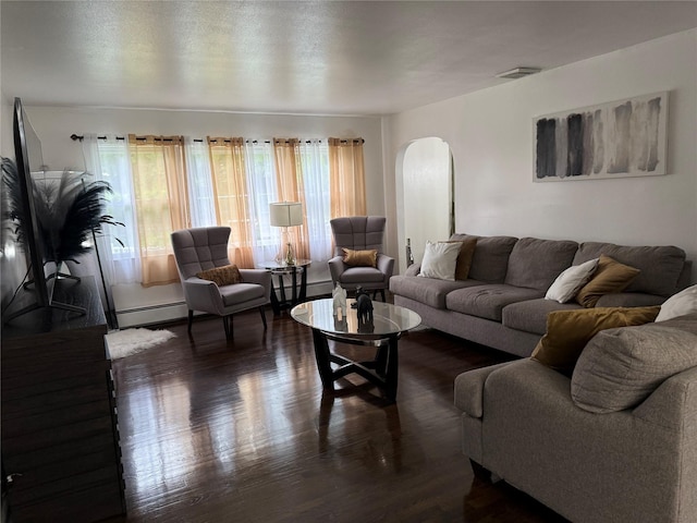 77 Upper Rd, Bloomingburg, NY 10940 - living area featuring arched walkways, baseboard heating, and wood finished floors