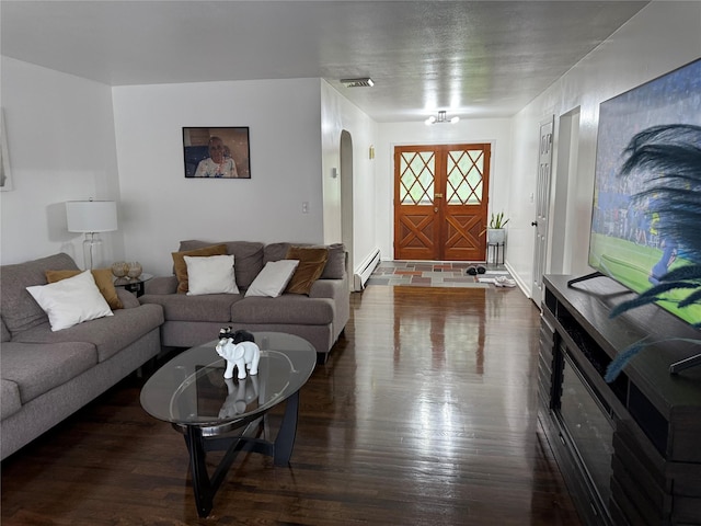 77 Upper Rd, Bloomingburg, NY 10940 - living room featuring arched walkways, dark wood-style flooring, and baseboard heating