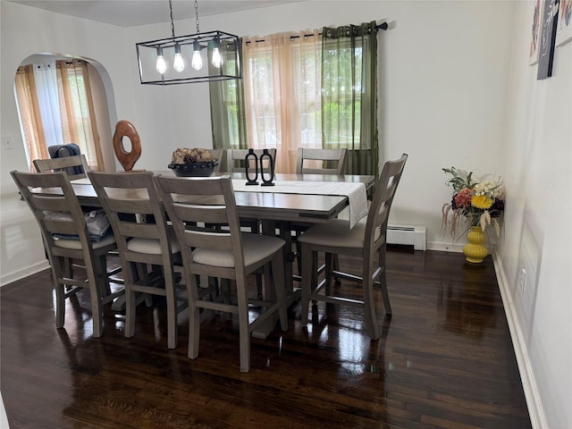 77 Upper Rd, Bloomingburg, NY 10940 - dining area featuring arched walkways, baseboards, dark wood-style floors, and a baseboard radiator