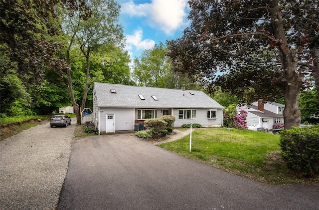 929 Fox Meadow Rd, Yorktown Heights, NY 10598 - view of front of home with asphalt driveway, a front yard, a shingled roof, and view of scattered trees