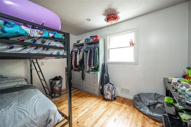 929 Fox Meadow Rd, Yorktown Heights, NY 10598 - bedroom with wood-type flooring, a textured ceiling, and a closet