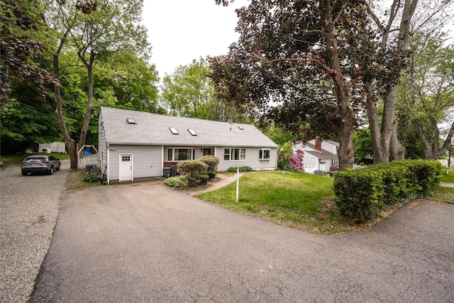 929 Fox Meadow Rd, Yorktown Heights, NY 10598 - view of front of home featuring asphalt driveway, a front yard, a shingled roof, and view of scattered trees