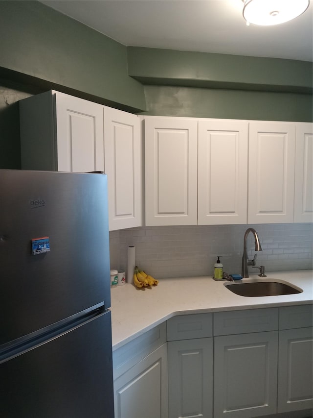 1920 Mcgraw Ave Unit 2G, Bronx, NY 10462 - kitchen featuring freestanding refrigerator, a sink, tasteful backsplash, and white cabinetry