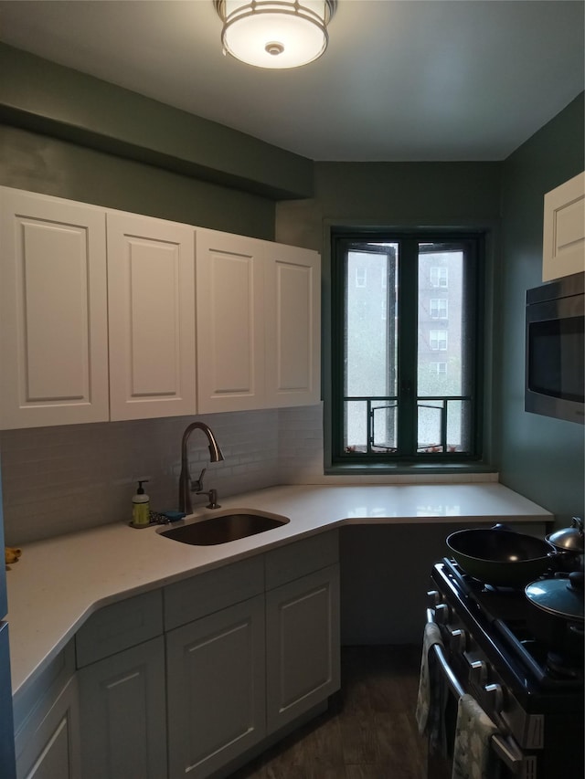 1920 Mcgraw Ave Unit 2G, Bronx, NY 10462 - kitchen featuring stainless steel microwave, a sink, gas range, light countertops, and dark wood-style floors