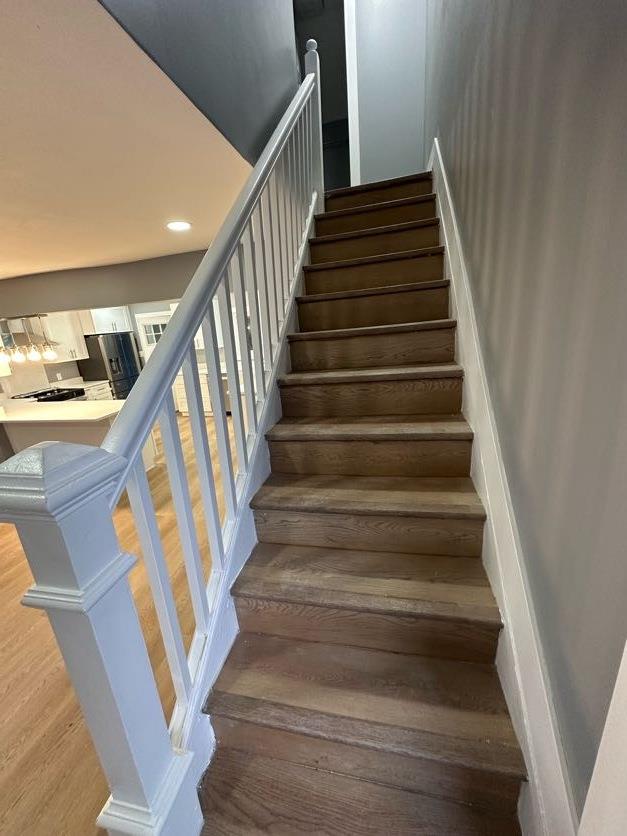 123 Mitchell St, North Bellmore, NY 11710 - stairs featuring wood finished floors and recessed lighting