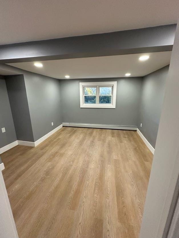 123 Mitchell St, North Bellmore, NY 11710 - basement featuring a baseboard heating unit, light wood-style floors, baseboards, and recessed lighting
