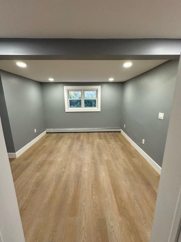 123 Mitchell St, North Bellmore, NY 11710 - basement featuring wood finished floors, baseboards, a baseboard radiator, and recessed lighting