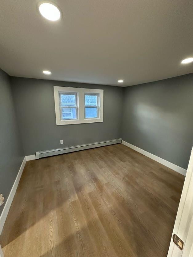 123 Mitchell St, North Bellmore, NY 11710 - unfurnished room with a baseboard radiator, baseboards, wood finished floors, and recessed lighting
