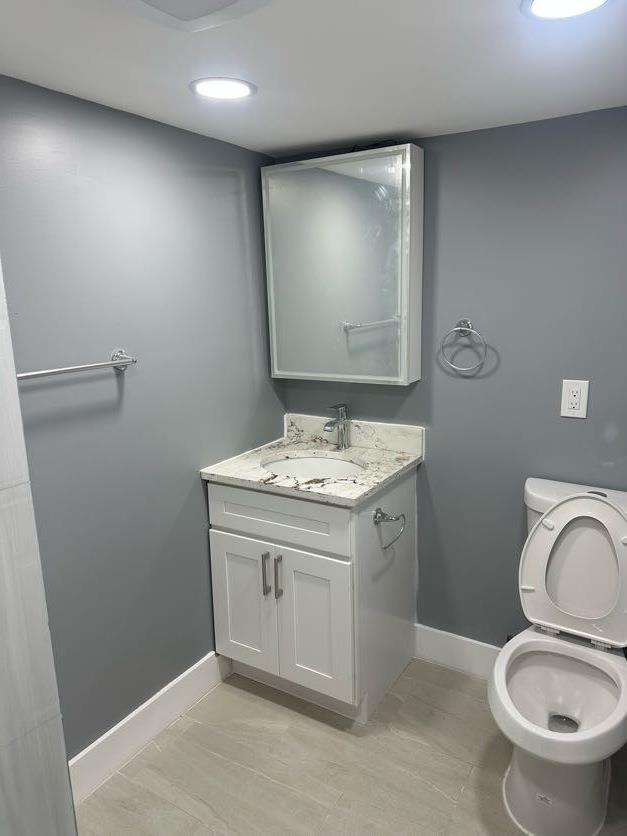 123 Mitchell St, North Bellmore, NY 11710 - bathroom with baseboards, vanity, and toilet
