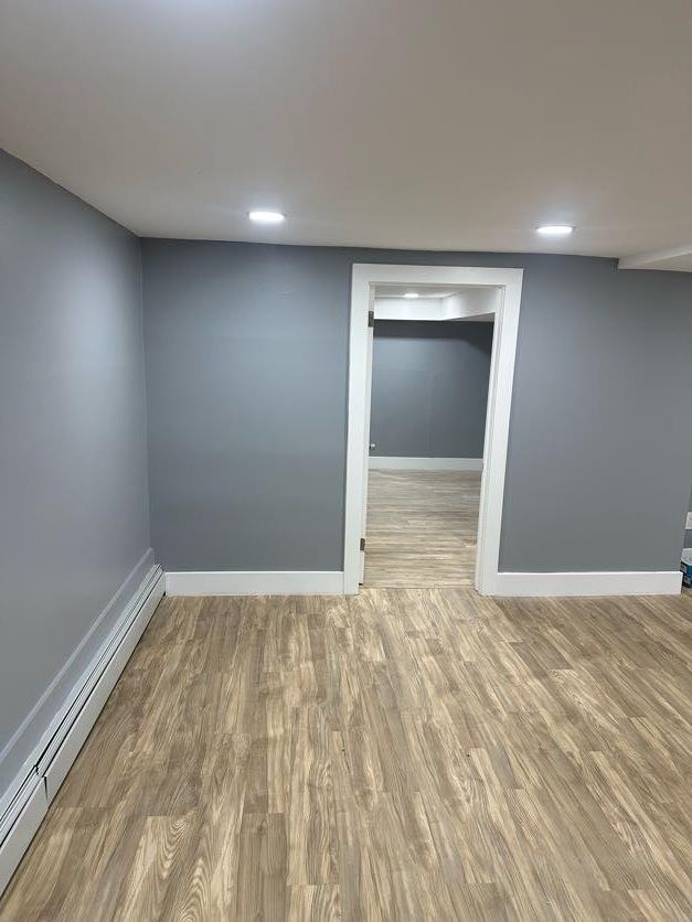123 Mitchell St, North Bellmore, NY 11710 - finished basement featuring baseboard heating, baseboards, and wood finished floors