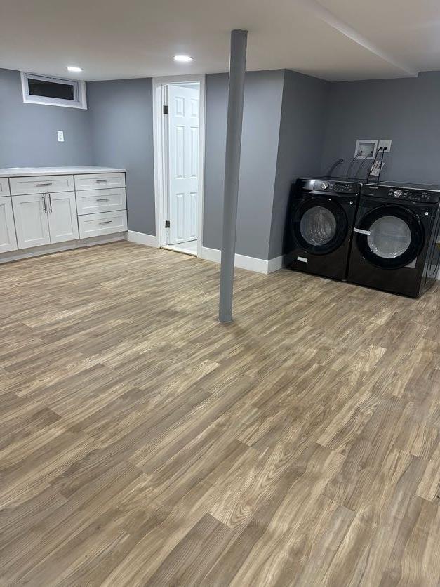 123 Mitchell St, North Bellmore, NY 11710 - washroom with washing machine and clothes dryer, light wood-style floors, baseboards, and recessed lighting