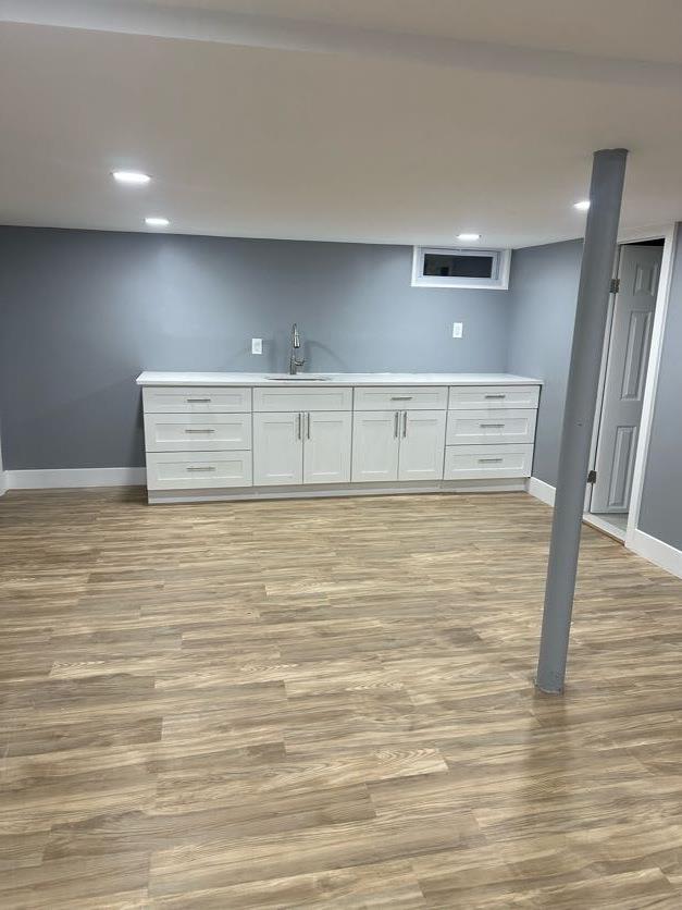 123 Mitchell St, North Bellmore, NY 11710 - finished below grade area featuring a sink, baseboards, light wood-style flooring, and recessed lighting