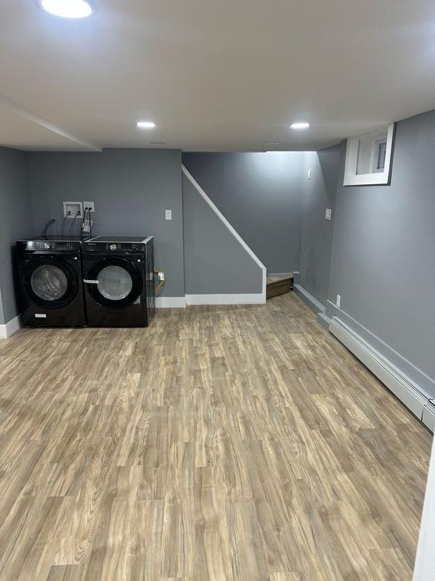 123 Mitchell St, North Bellmore, NY 11710 - laundry room featuring washer and clothes dryer, baseboards, wood finished floors, and baseboard heating
