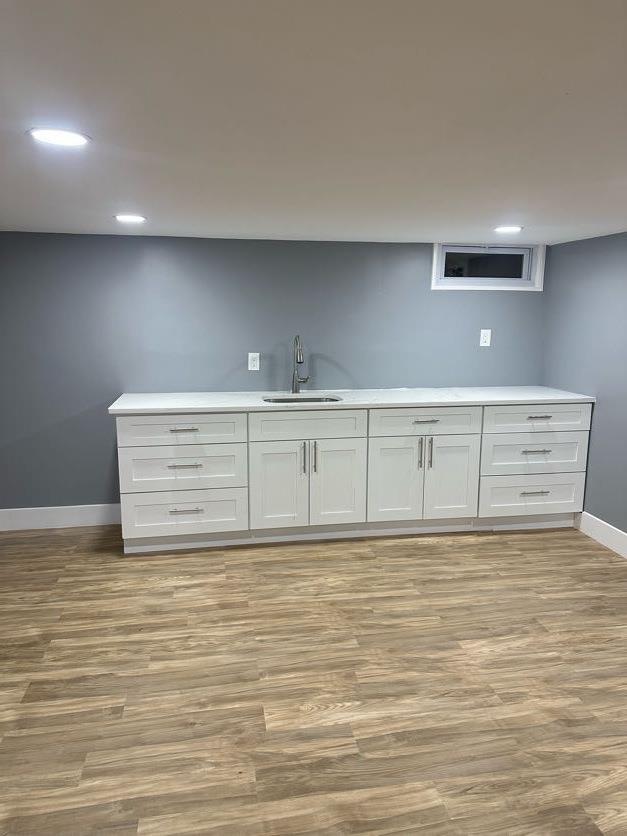 123 Mitchell St, North Bellmore, NY 11710 - bar area with a sink, baseboards, light wood-style floors, and recessed lighting