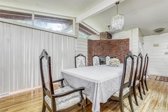 581 Union Rd, Spring Valley, NY 10977 - dining space with wood finished floors, wooden walls, and a chandelier