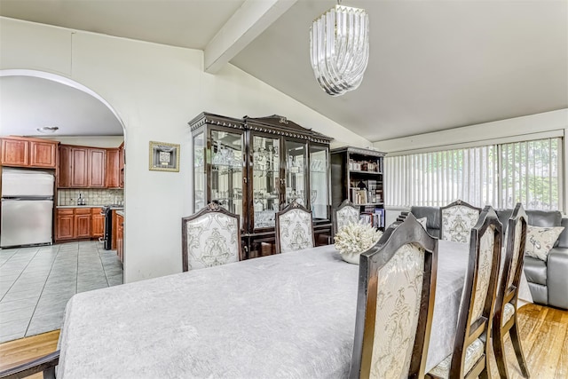 581 Union Rd, Spring Valley, NY 10977 - dining area with arched walkways, a chandelier, and light tile patterned flooring