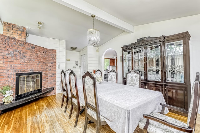 581 Union Rd, Spring Valley, NY 10977 - dining room with a chandelier, hardwood / wood-style flooring, and a brick fireplace