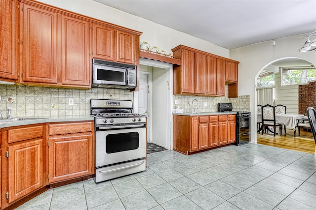 581 Union Rd, Spring Valley, NY 10977 - kitchen featuring appliances with stainless steel finishes, light countertops, light tile patterned flooring, and a sink