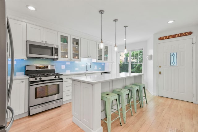 2032 Palmer Ave, Larchmont, NY 10538 - kitchen with stainless steel appliances, a sink, light countertops, tasteful backsplash, and white cabinets