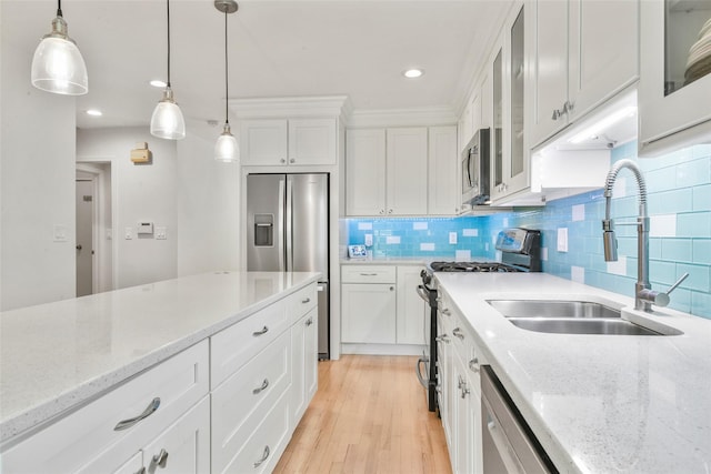 2032 Palmer Ave, Larchmont, NY 10538 - kitchen featuring appliances with stainless steel finishes, a sink, white cabinets, light wood-type flooring, and decorative backsplash