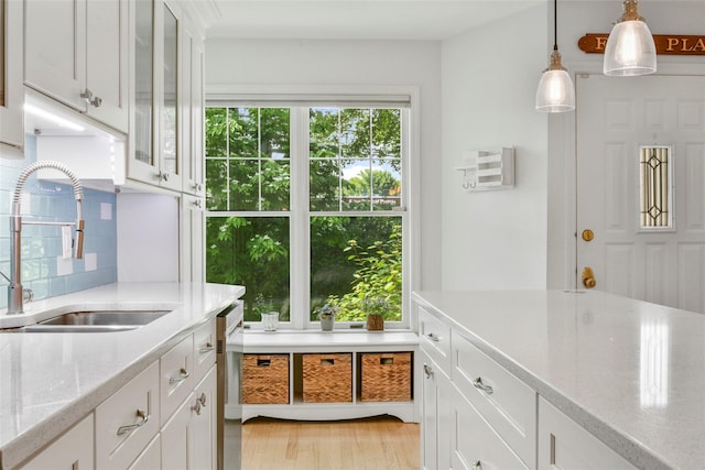 2032 Palmer Ave, Larchmont, NY 10538 - kitchen with a sink, tasteful backsplash, hanging light fixtures, light wood finished floors, and white cabinets