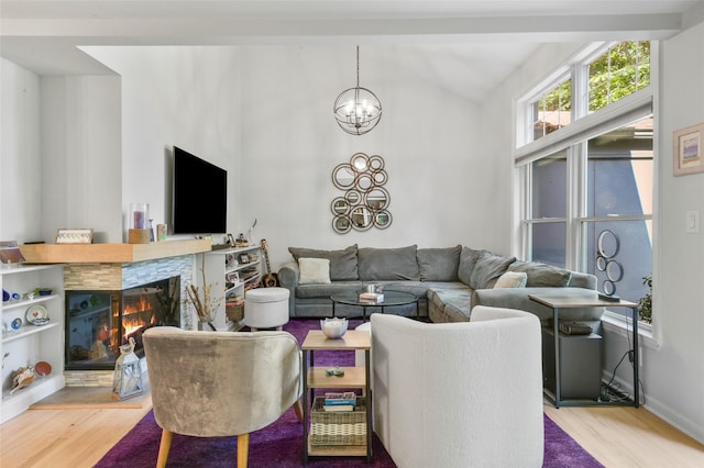 2032 Palmer Ave, Larchmont, NY 10538 - living area featuring vaulted ceiling, wood finished floors, a chandelier, and a multi sided fireplace