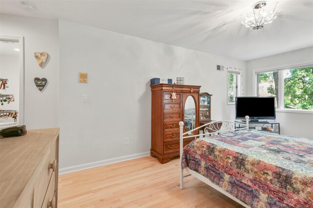 2032 Palmer Ave, Larchmont, NY 10538 - bedroom featuring light wood-type flooring, baseboards, and a chandelier