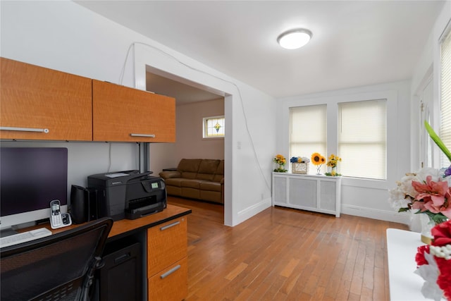 114-18 175th St, Addisleigh Park, NY 11434 - home office featuring radiator heating unit, light wood-style flooring, and baseboards