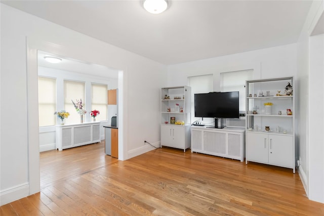 114-18 175th St, Addisleigh Park, NY 11434 - living area featuring light wood finished floors, a desk, and baseboards