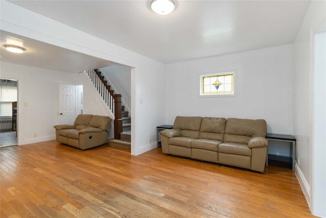 114-18 175th St, Addisleigh Park, NY 11434 - living area featuring light wood-type flooring, stairs, radiator, and baseboards