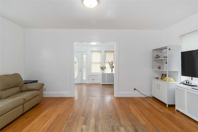 114-18 175th St, Addisleigh Park, NY 11434 - living room with radiator heating unit, baseboards, and light wood finished floors