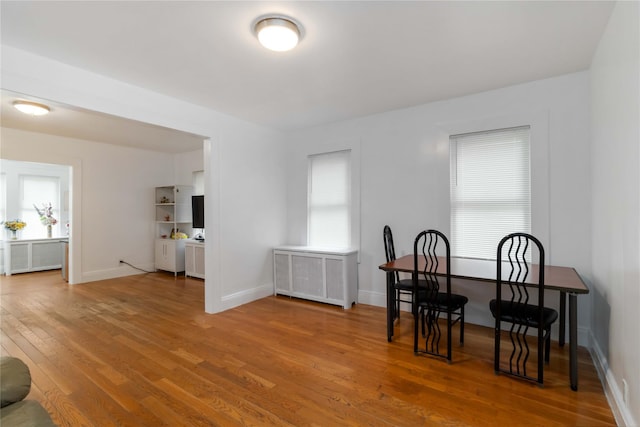 114-18 175th St, Addisleigh Park, NY 11434 - dining room featuring radiator, wood finished floors, and baseboards