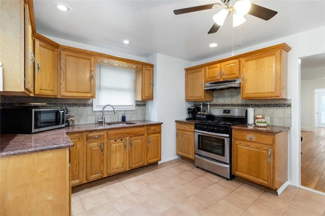 114-18 175th St, Addisleigh Park, NY 11434 - kitchen featuring stainless steel appliances, a sink, under cabinet range hood, decorative backsplash, and ceiling fan