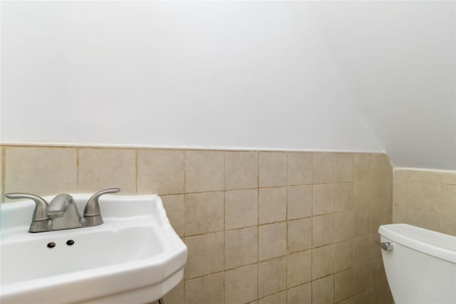 114-18 175th St, Addisleigh Park, NY 11434 - bathroom featuring a sink, toilet, a wainscoted wall, and tile walls