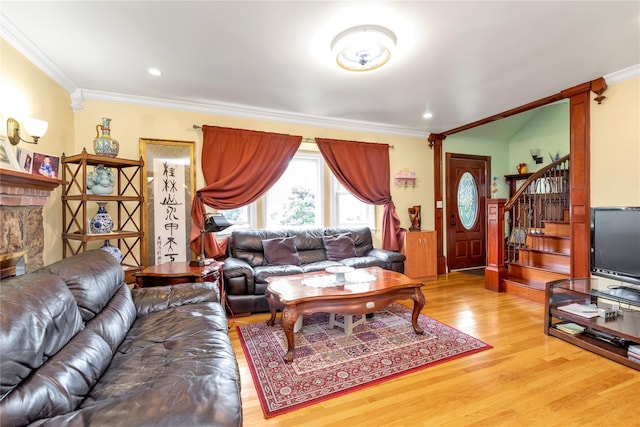 590 Langley Ave, West Hempstead, NY 11552 - living room featuring ornamental molding, light wood-style flooring, stairway, a brick fireplace, and recessed lighting
