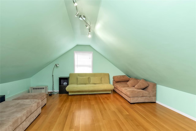 590 Langley Ave, West Hempstead, NY 11552 - additional living space with vaulted ceiling, light wood-type flooring, baseboards, and a wall mounted air conditioner