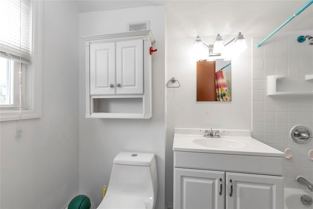 590 Langley Ave, West Hempstead, NY 11552 - bathroom featuring vanity, tub / shower combination, and toilet