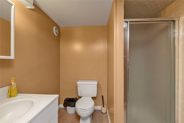 590 Langley Ave, West Hempstead, NY 11552 - bathroom with toilet, vanity, a shower stall, tile patterned floors, and baseboards