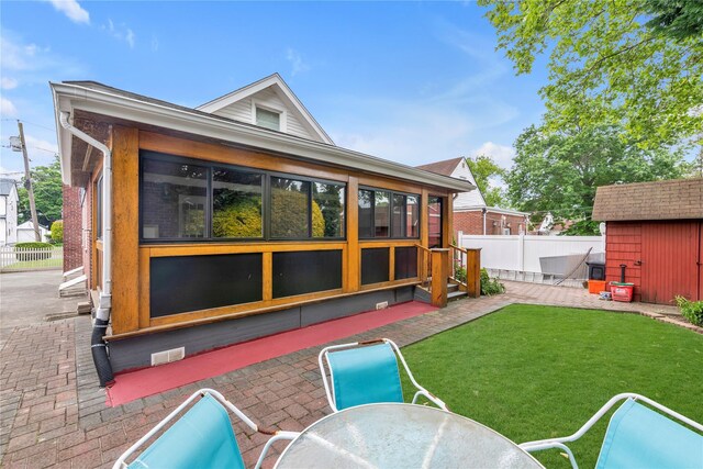 590 Langley Ave, West Hempstead, NY 11552 - back of property with a sunroom and a patio area