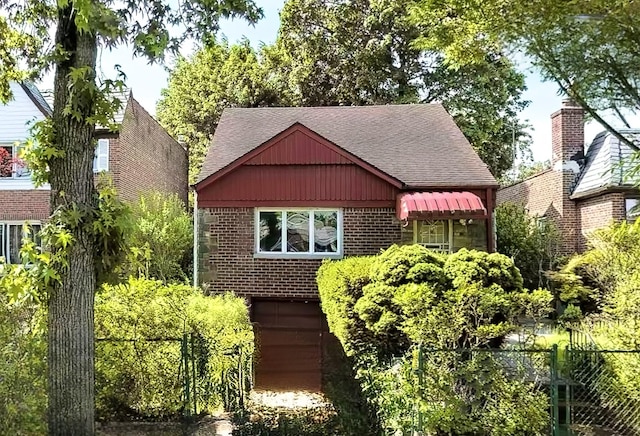 85-82 66th Rd, Rego Park, NY 11374 - view of front facade featuring a shingled roof, brick siding, and a garage