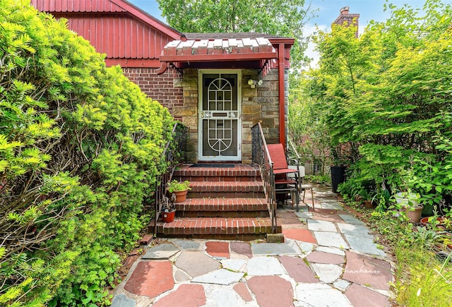 85-82 66th Rd, Rego Park, NY 11374 - doorway to property featuring board and batten siding, brick siding, and stone siding