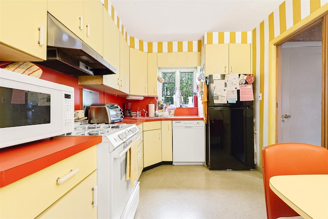 85-82 66th Rd, Rego Park, NY 11374 - kitchen featuring white appliances, under cabinet range hood, wallpapered walls, decorative backsplash, and cream cabinetry